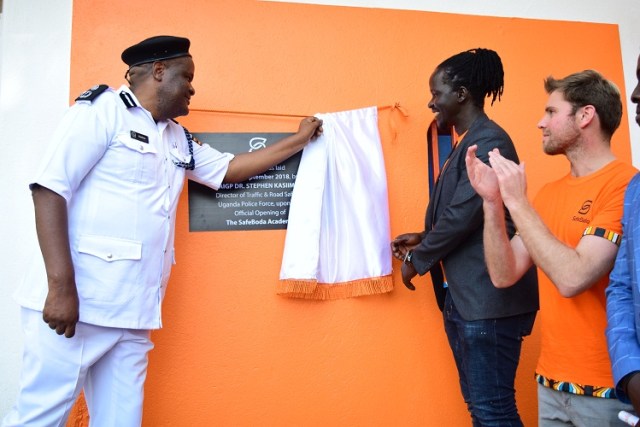 Dr. Steven Kasiima, the Director Traffic Police (L) officially opening the Academy.