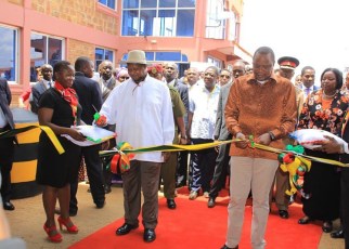 Uganda President Yoweri Museveni and his Kenya counterpart Uhuru Kenyatta cutting a ribbon in a recent function at the Busia border post as part of their mission to boost trade between the two countries at the one stop border post