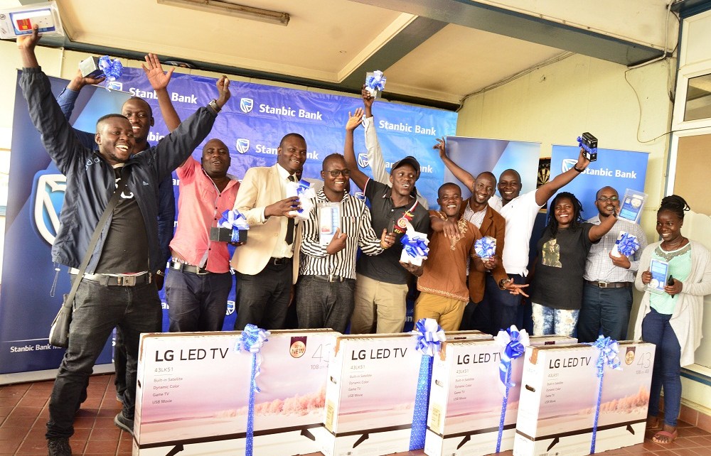 24 lucky winners of the 12 Days of Christmas Campaign pause for a group photo with their gifts at the Stanbic Bank Headquarters. The campaign which kicked off on 4th December and ended on the 19th of Dece.jpg