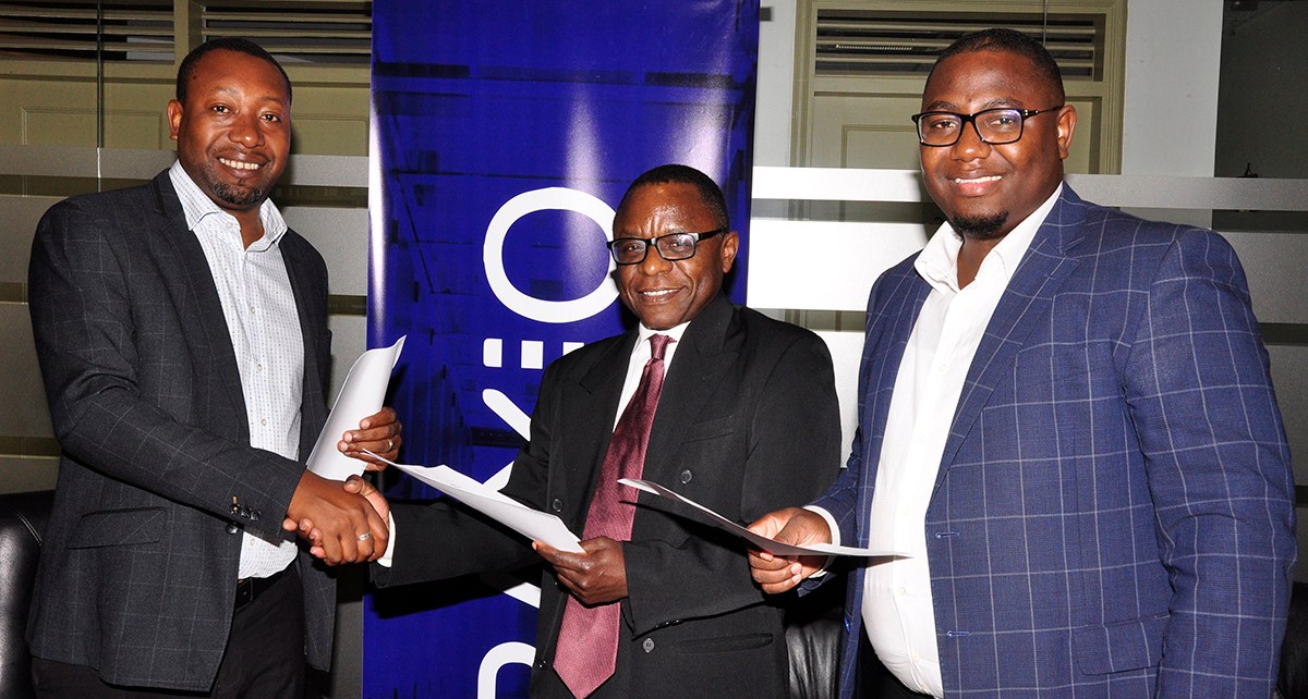 Raxio General Manager James Byaruhanga and Paul Nalikka, Director, Hamilton Telecom, flanked by Ahura Vianne Allan the CFO, signed for their respective organisations, at Raxio’s offices at Rwenzori Towers, Nakasero, Kampala
