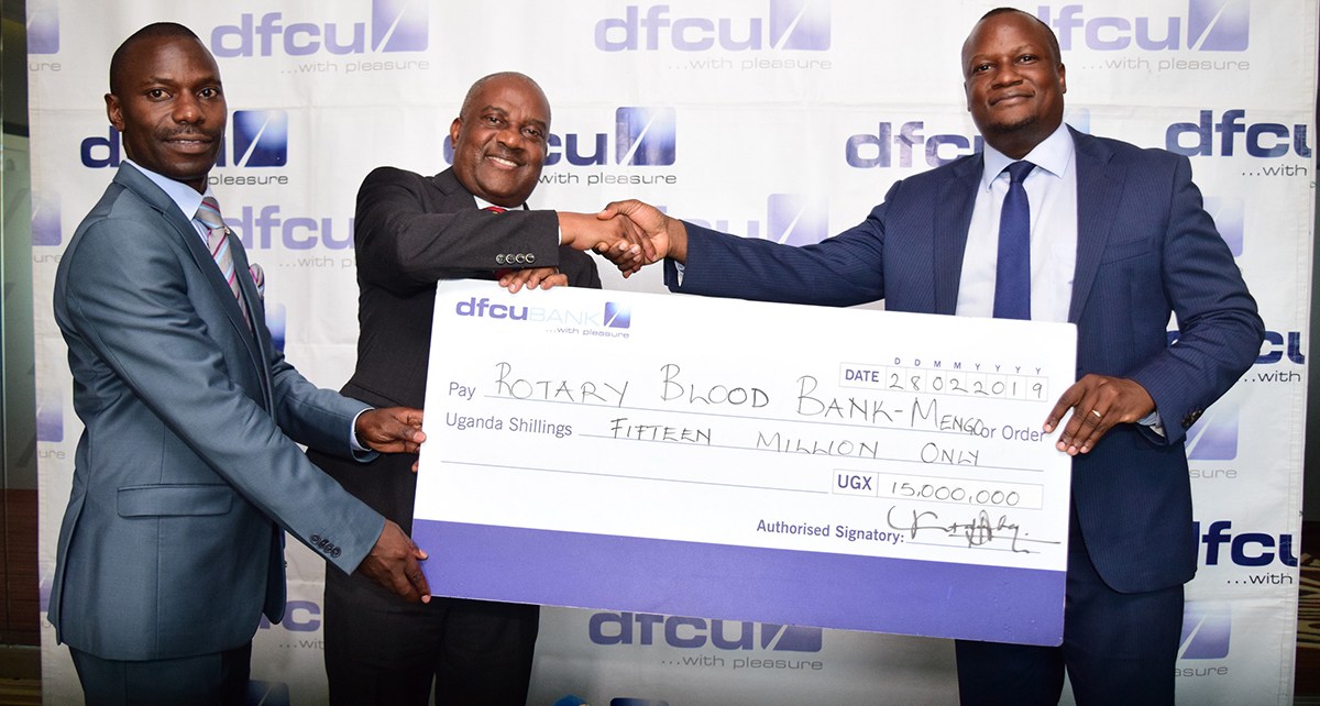 dfcu CEO Mathias Katamba hands over cheque for Rotary Blood Bank Mengo