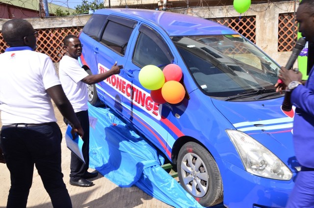 Paddy Muramiirah (R), CEO Crown Beverages (Pepsi) after test-running  one of the cars while Mr. Isaac Sekasi (L) and other Crown Beverages looks on during the media launch of the Tukonectinge with Pepsi Campaign that took place today, 11th April 2018 at the company's Headquarters in Nakawa industrial area. 