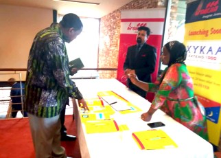 Commissioner Patrick Tusiime being briefed by one of Troikaa representative on the various products they offer on the Ugandan markets
