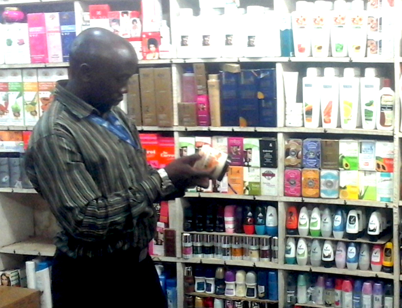 Uganda National Bureau of Standards official checks suspected substandard cosmetics in a shop in Kampala