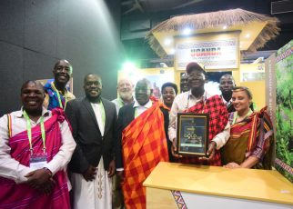Prof. Ephraim Kamuntu, the Minister of Tourism Wildlife and Antiquities holds the Gold Award certificate presented to Uganda Tourism Board in the category of Southern Africa Development Community and Africa.