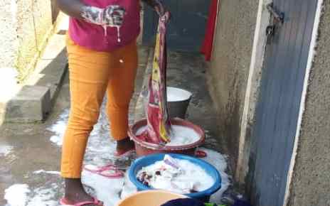 Akello is able to pay for her tuition with money earned from doing laundry