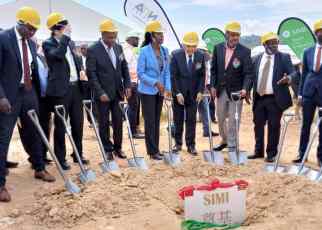 Minister Frank Tumwebaze 5th from Right with other officials at holding spades during the ground breaking for the construction of the facility