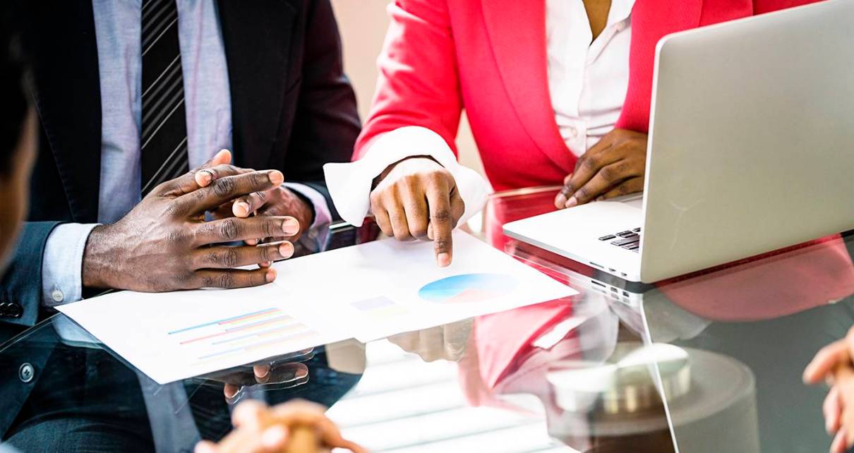 Successful Business People discussing the Facts & Figures of their business in an office Boardroom.