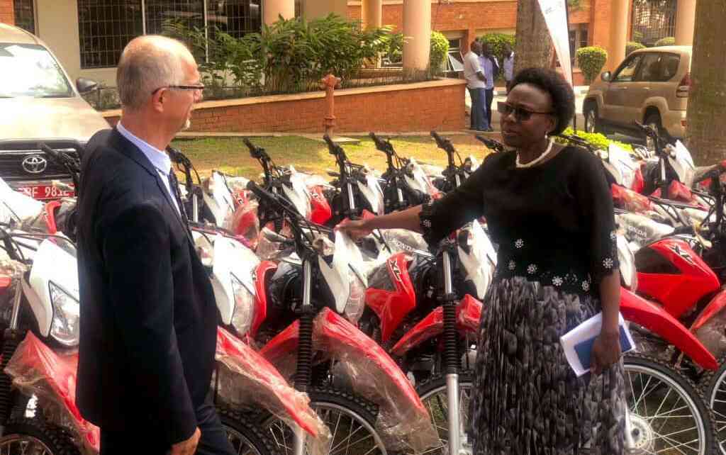 Health Minister Ruth Aceng (Right) receiving the motorcycles and ambulances from UNHCR’s Joël Boutroue in Kampala on August 22