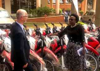 Health Minister Ruth Aceng (Right) receiving the motorcycles and ambulances from UNHCR’s Joël Boutroue in Kampala on August 22