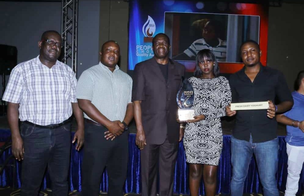 Joseph Awino - General Manager Sales Fresh Dairy(L), Vincent Omoth - Marketing Manager Fresh Dairy (2L), Hon. Micheal Werikhe – Minister of State for Trade (C), Rita Bwiza – Customer Care Executive Fresh Dairy (2R) and Edgar Wabulo – Sales Operations (R ) pose with the People’s Choice Award 2019 – Yoghurt Category that Fresh Dairy won. Fresh Dairy Flavoured yoghurt is popular for its thickness, creaminess, aroma, flavours and natural taste.