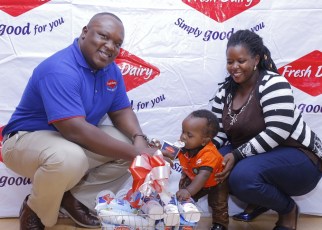 Vincent Omoth Marketing Manager Fresh Dairy (Left) hands over an assortment of Fresh Dairy products to Nellywn Ahirweomugisha (Centre) and his mother (Right).