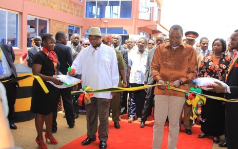 Uganda President Yoweri Museveni and his Kenya counterpart Uhuru Kenyatta cutting a ribbon in a recent function at the Busia border post as part of their mission to boost trade between the two countries at the one stop border post
