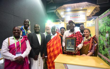 Prof. Ephraim Kamuntu, the Minister of Tourism Wildlife and Antiquities holds the Gold Award certificate presented to Uganda Tourism Board in the category of Southern Africa Development Community and Africa.