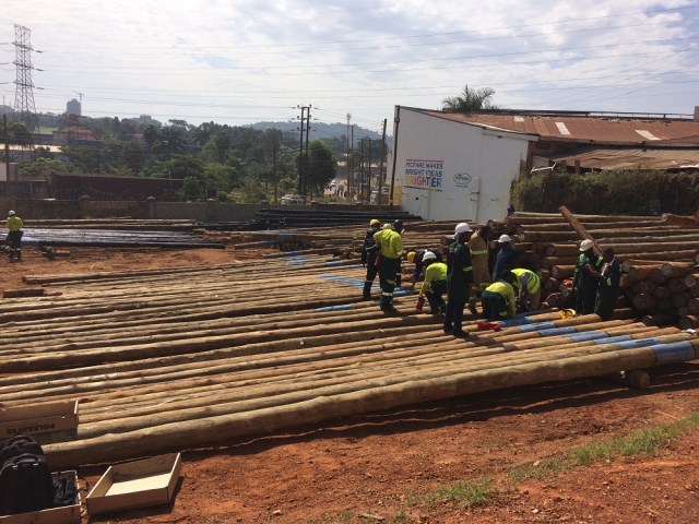 Umeme employees sorting out wooden poles at their yard in Lugogo Kampala. In the near future, the company will stop using wooden poles.